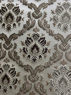 Decorative fabric with intricate Brown floral pattern on a beige background