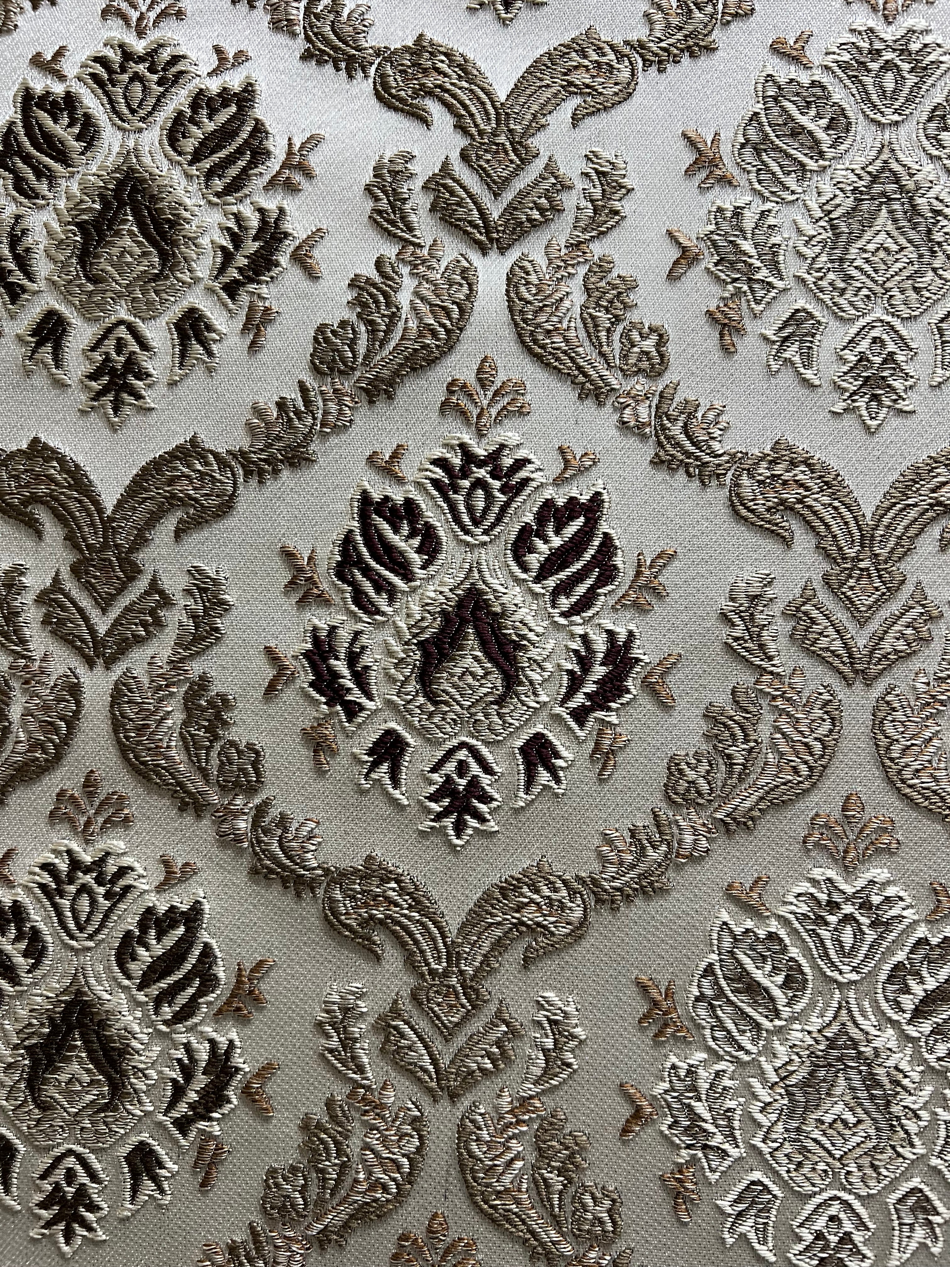 Decorative fabric with intricate Brown floral pattern on a beige background