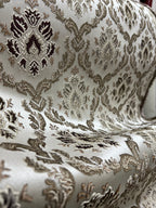 Decorative fabric with intricate Brown floral pattern on a beige background