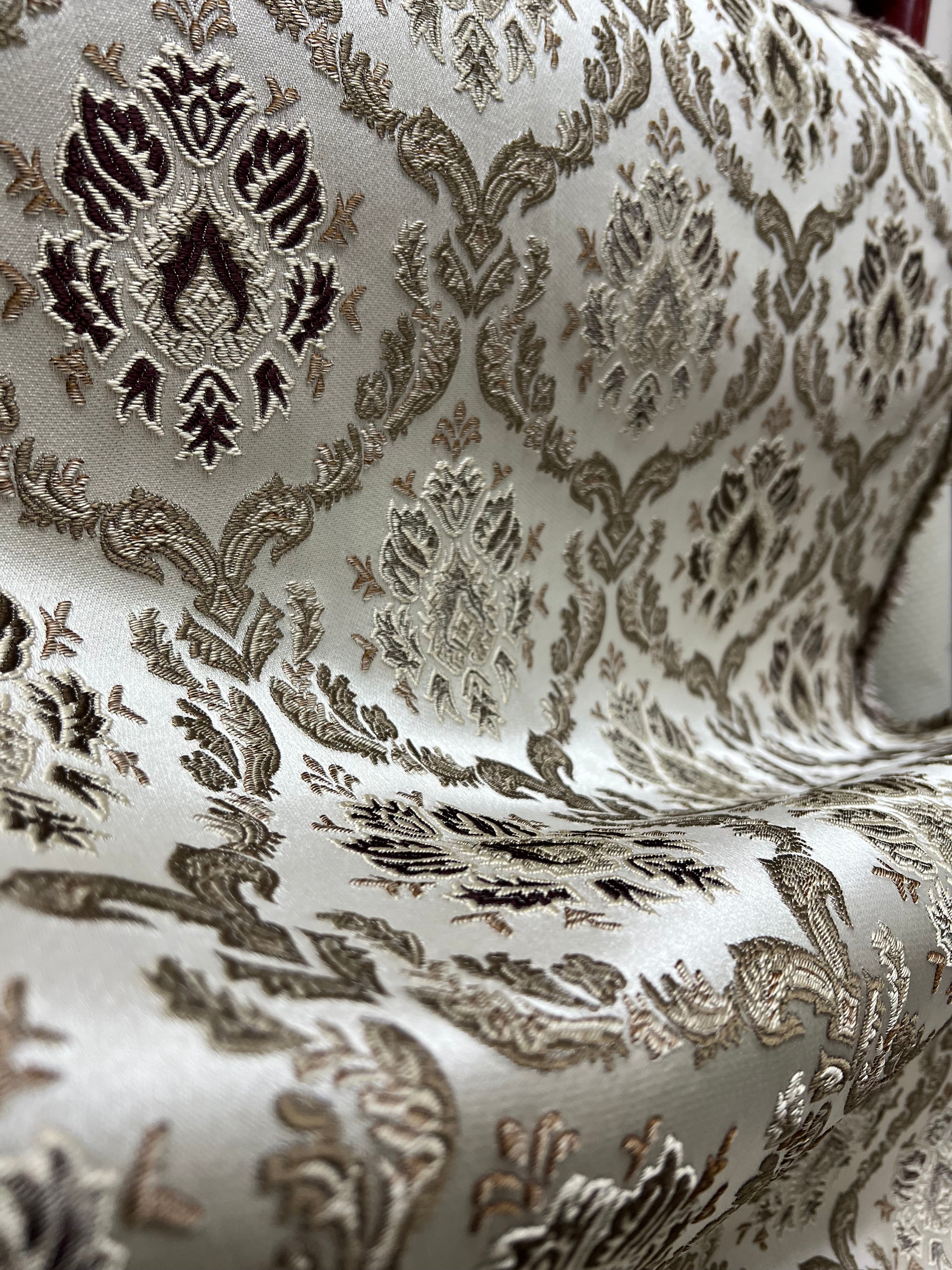 Decorative fabric with intricate Brown floral pattern on a beige background