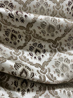 Decorative fabric with intricate Brown floral pattern on a beige background