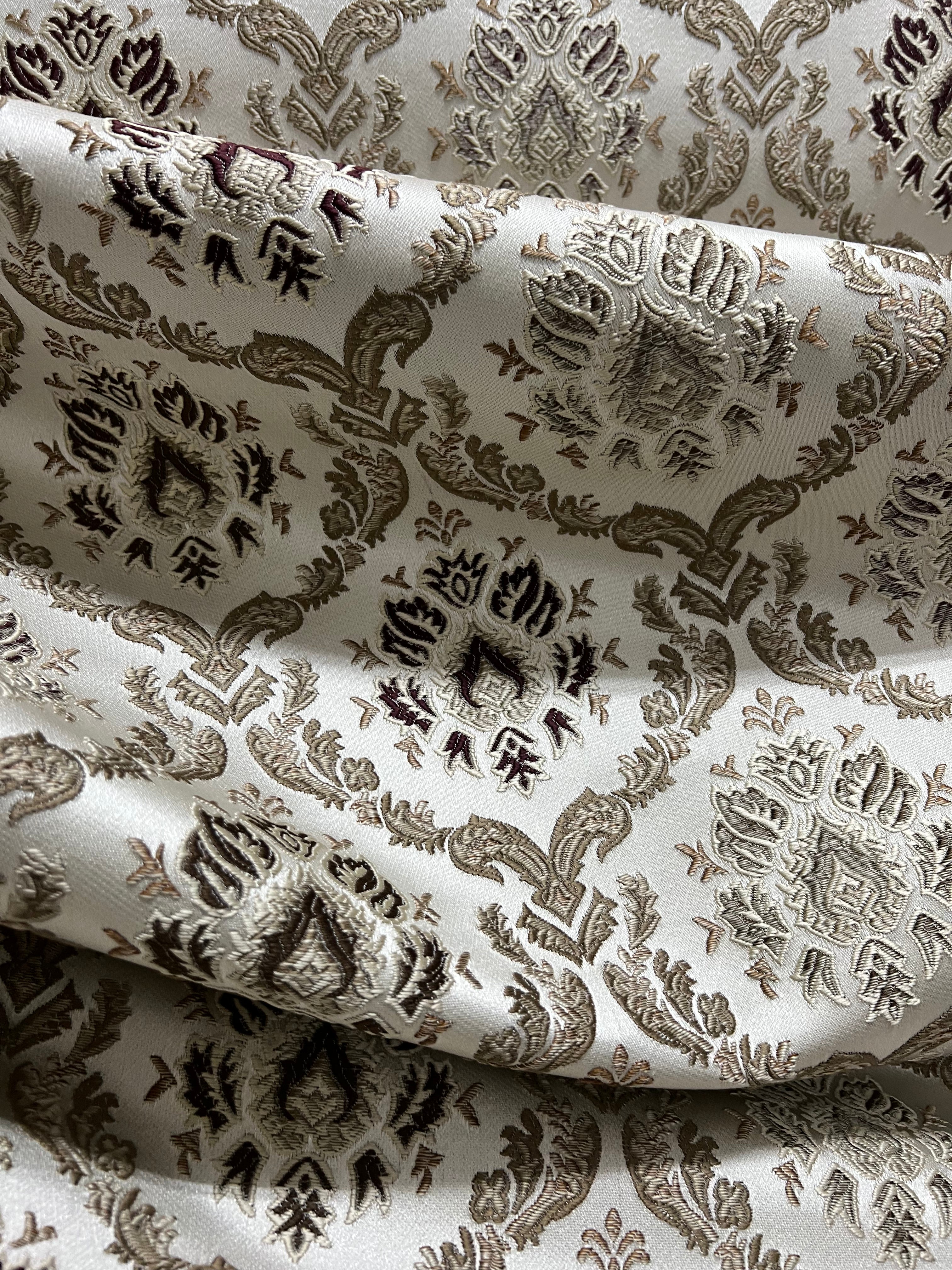 Decorative fabric with intricate Brown floral pattern on a beige background