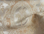 Close-up of damask ornate floral pattern on fabric with Beige color background