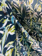 Floral pattern with green leaves and white flowers on Peacock Blue background