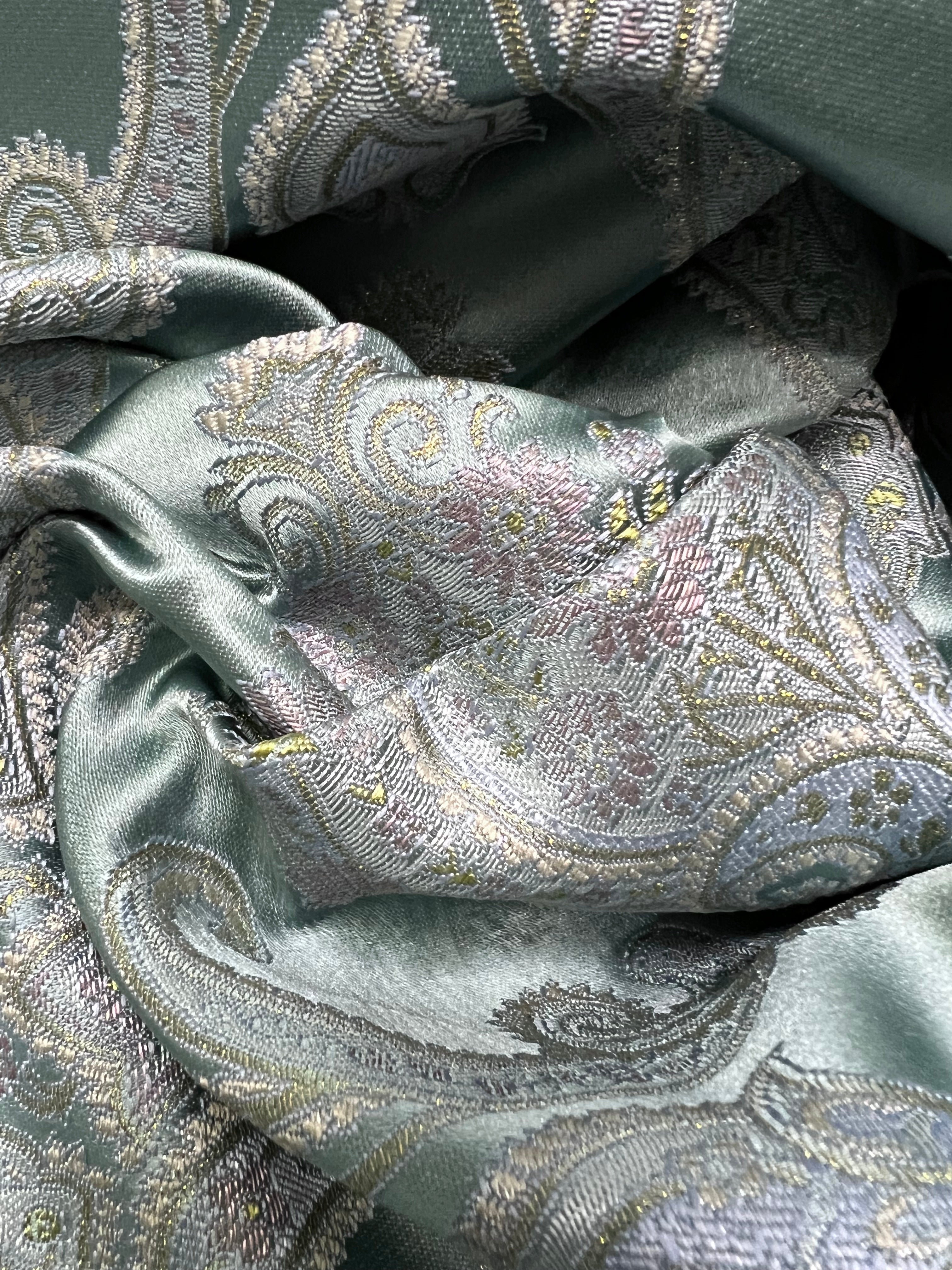 Decorative Damask Paisley pattern with intricate designs on a Teal Blue background