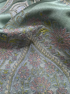 Decorative Damask Paisley pattern with intricate designs on a Teal Blue background
