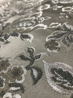 Silver floral jacquard fabric swatch showing repeat pattern detail.