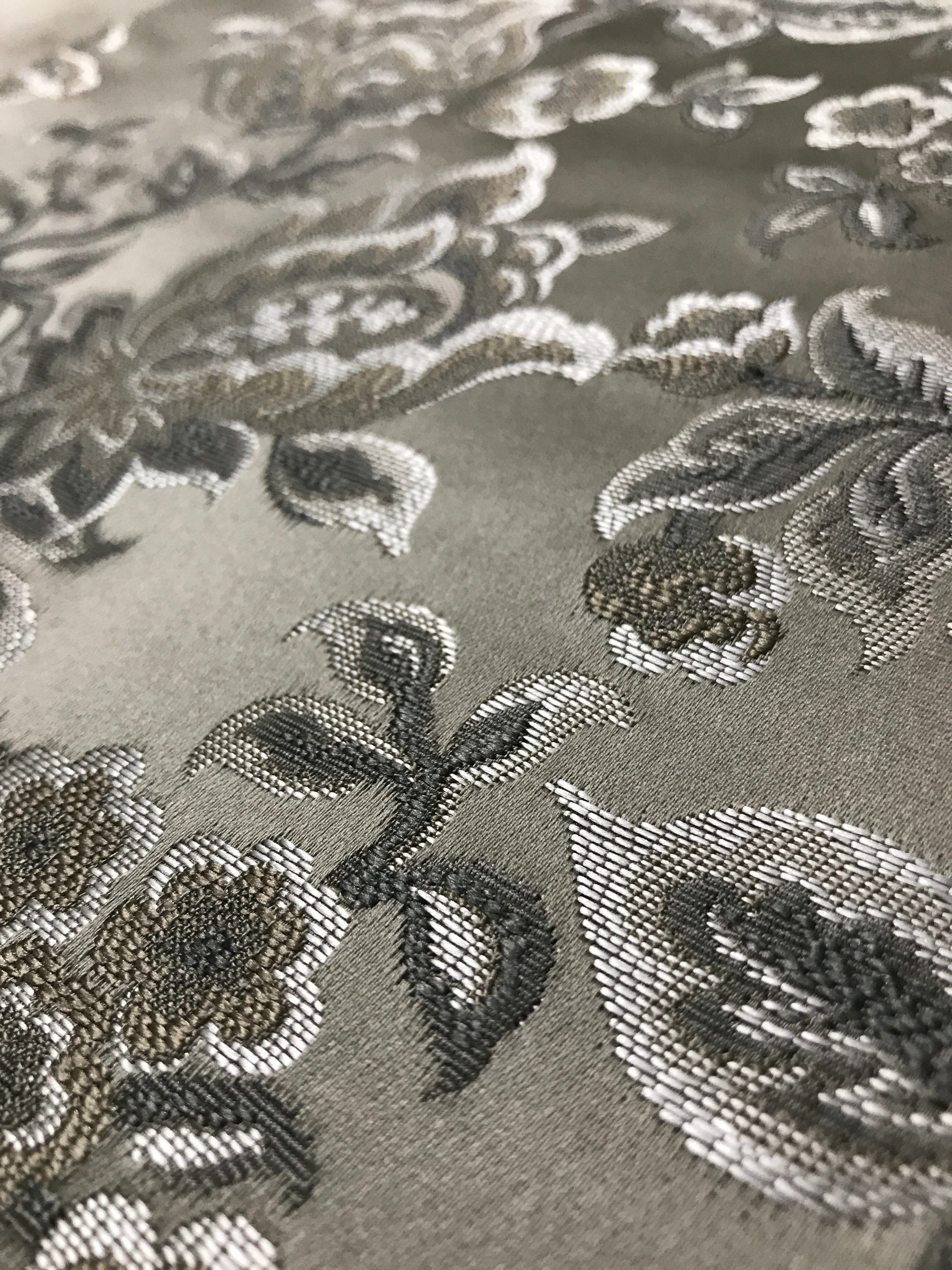 Silver floral jacquard fabric swatch showing repeat pattern detail.