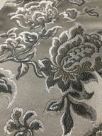 Silver floral jacquard fabric folded, texture close-up.
