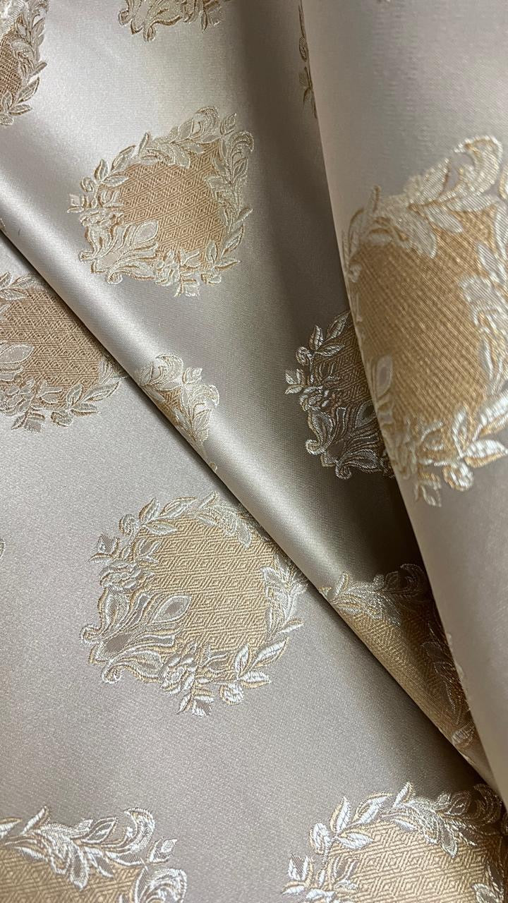 Decorative fabric pattern with intricate white designs on a Beige background