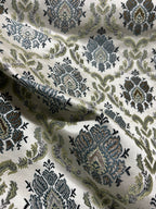 Decorative fabric with intricate Blue floral pattern on a beige background