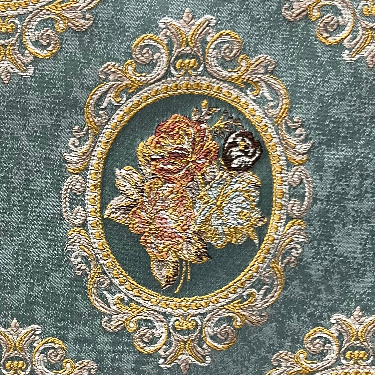 Decorative fabric with floral embroidery and intricate pattern such as Victorian Mirror Floral on an Teal Blue background