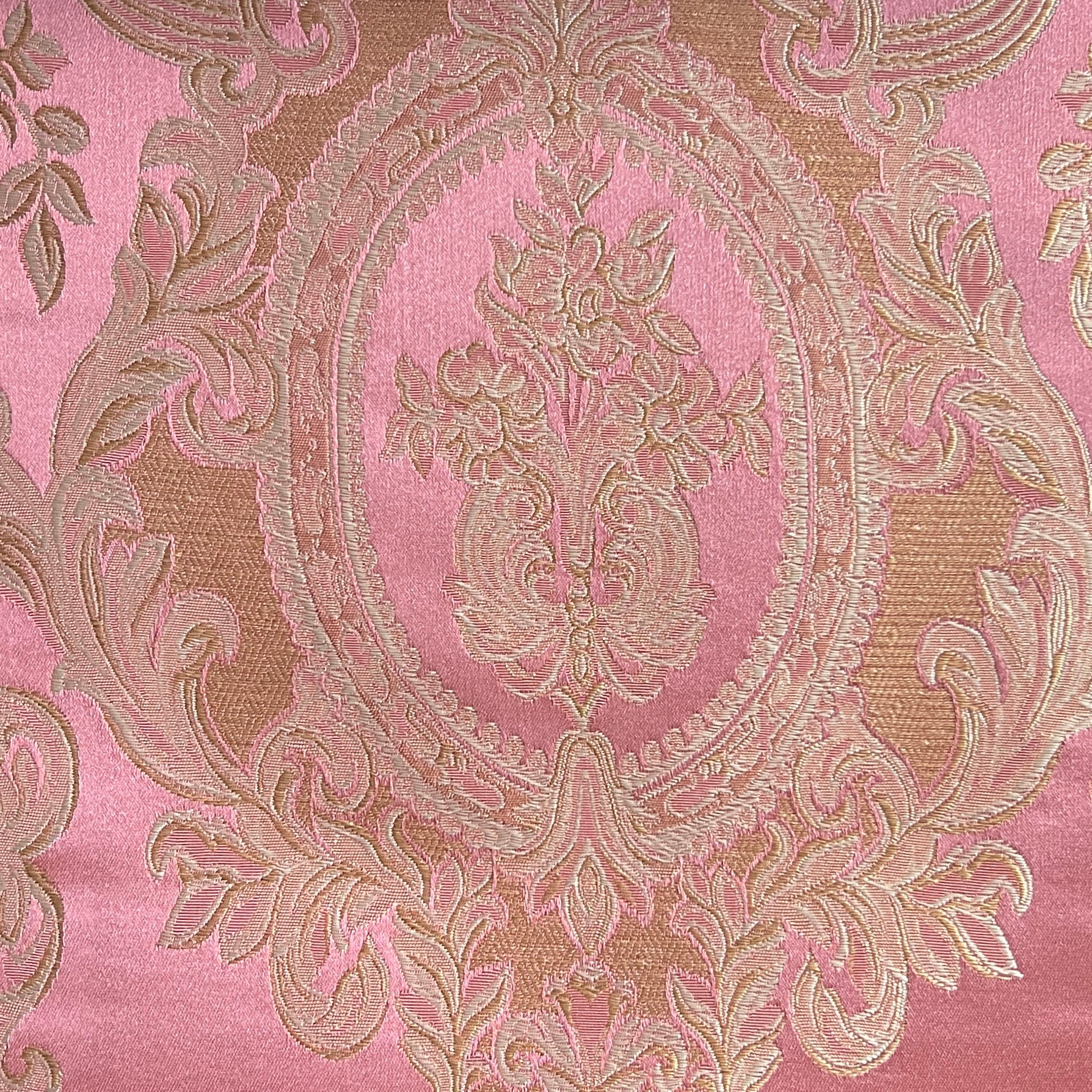 Close-up of damask ornate floral pattern on fabric with Rosewood color background