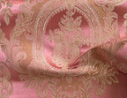 Close-up of damask ornate floral pattern on fabric with Rosewood color background