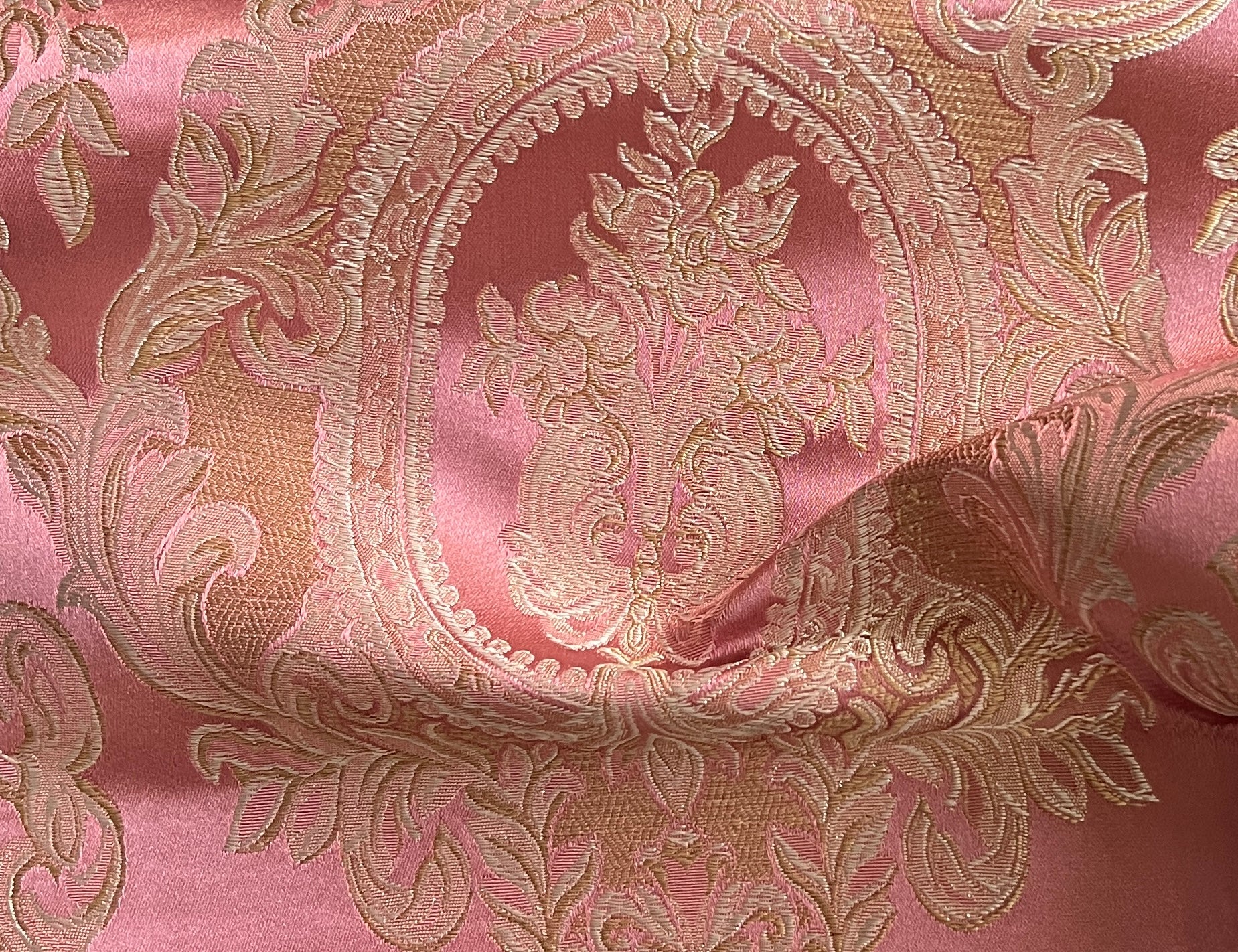 Close-up of damask ornate floral pattern on fabric with Rosewood color background