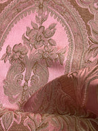 Close-up of damask ornate floral pattern on fabric with Rosewood color background