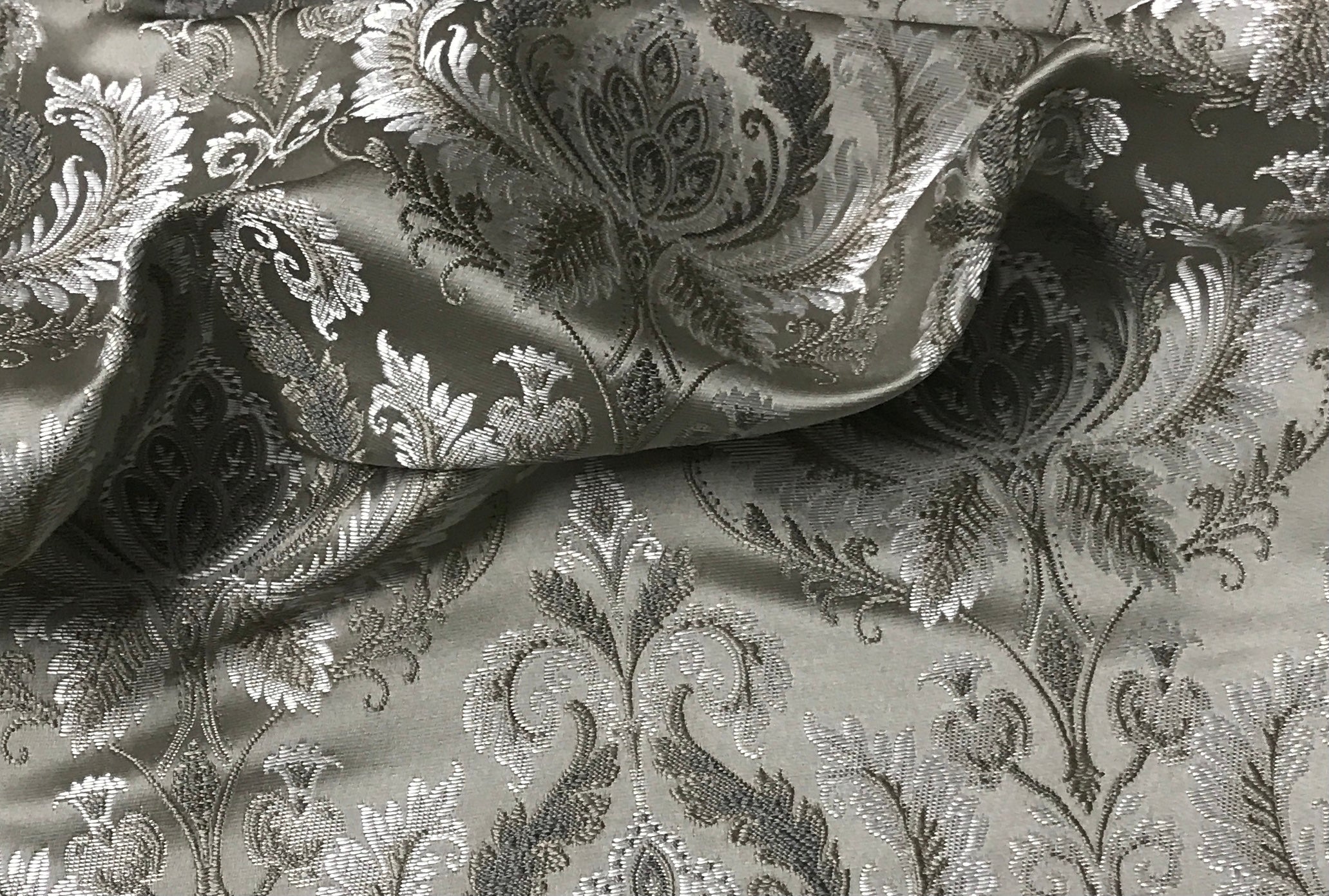 Silver damask fabric swatch showing repeat pattern detail