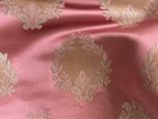 Decorative fabric pattern with intricate white designs on a Rosewood background