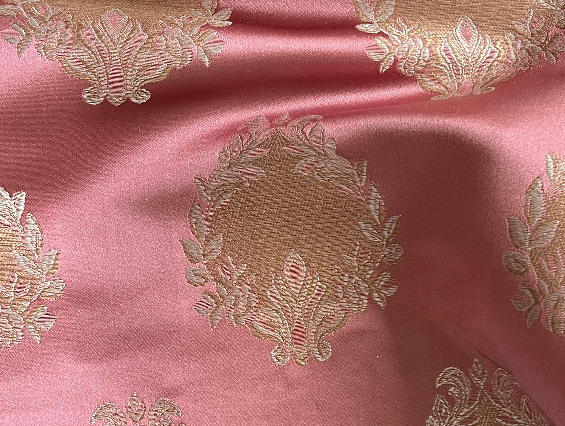 Decorative fabric pattern with intricate white designs on a Rosewood background