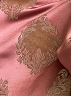 Decorative fabric pattern with intricate white designs on a Rosewood background