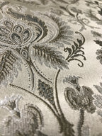 Silver damask fabric folded, texture and sheen close-up
