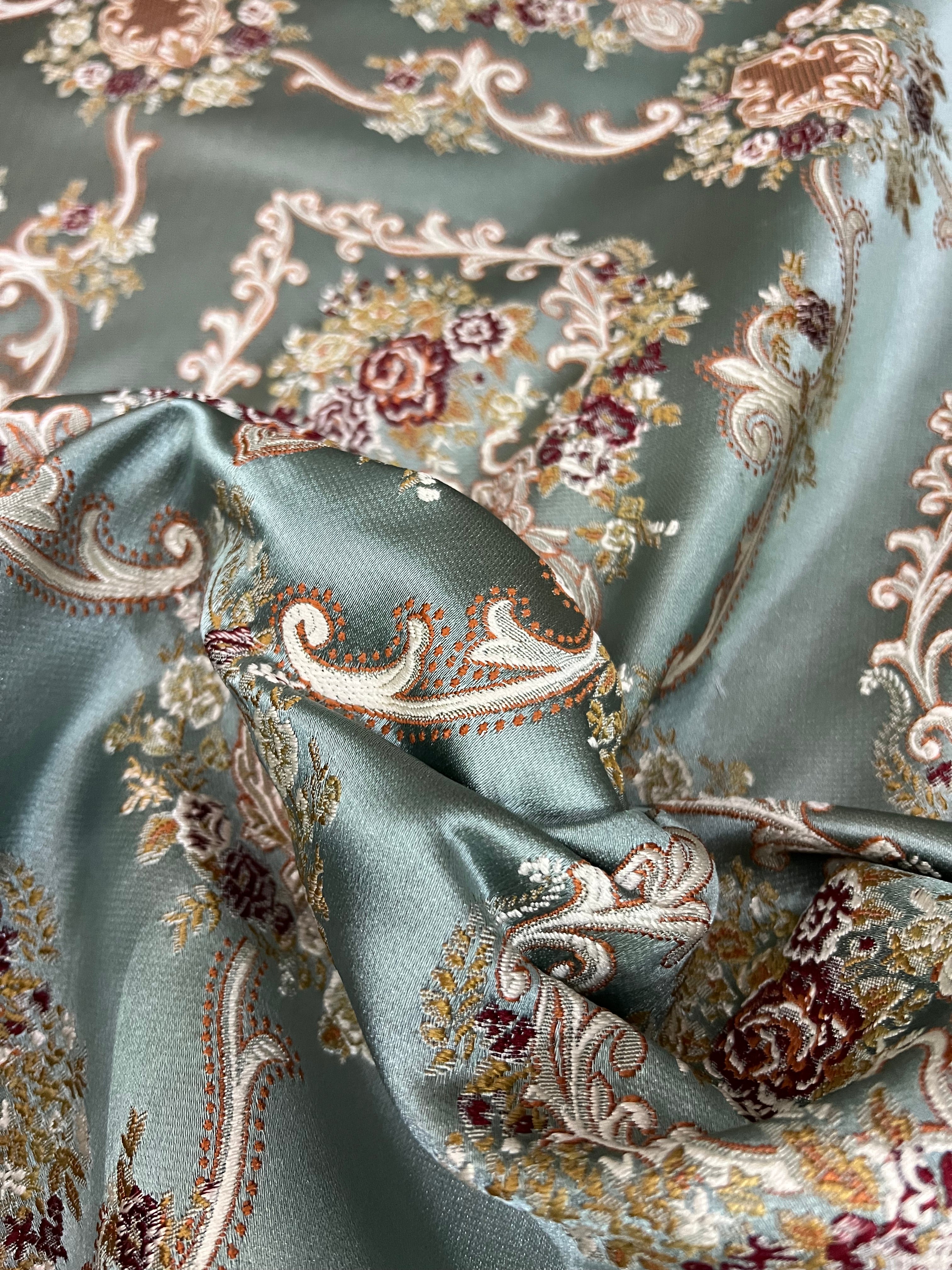 Decorative fabric with intricate floral damask on Teal Blue background