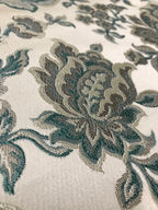 Sapphire blue floral jacquard fabric folded, texture close-up.