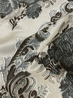 Decorative floral and baroque damask pattern on a beige background with Gray design