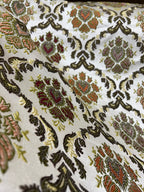 Decorative fabric with intricate Green floral pattern on a beige background
