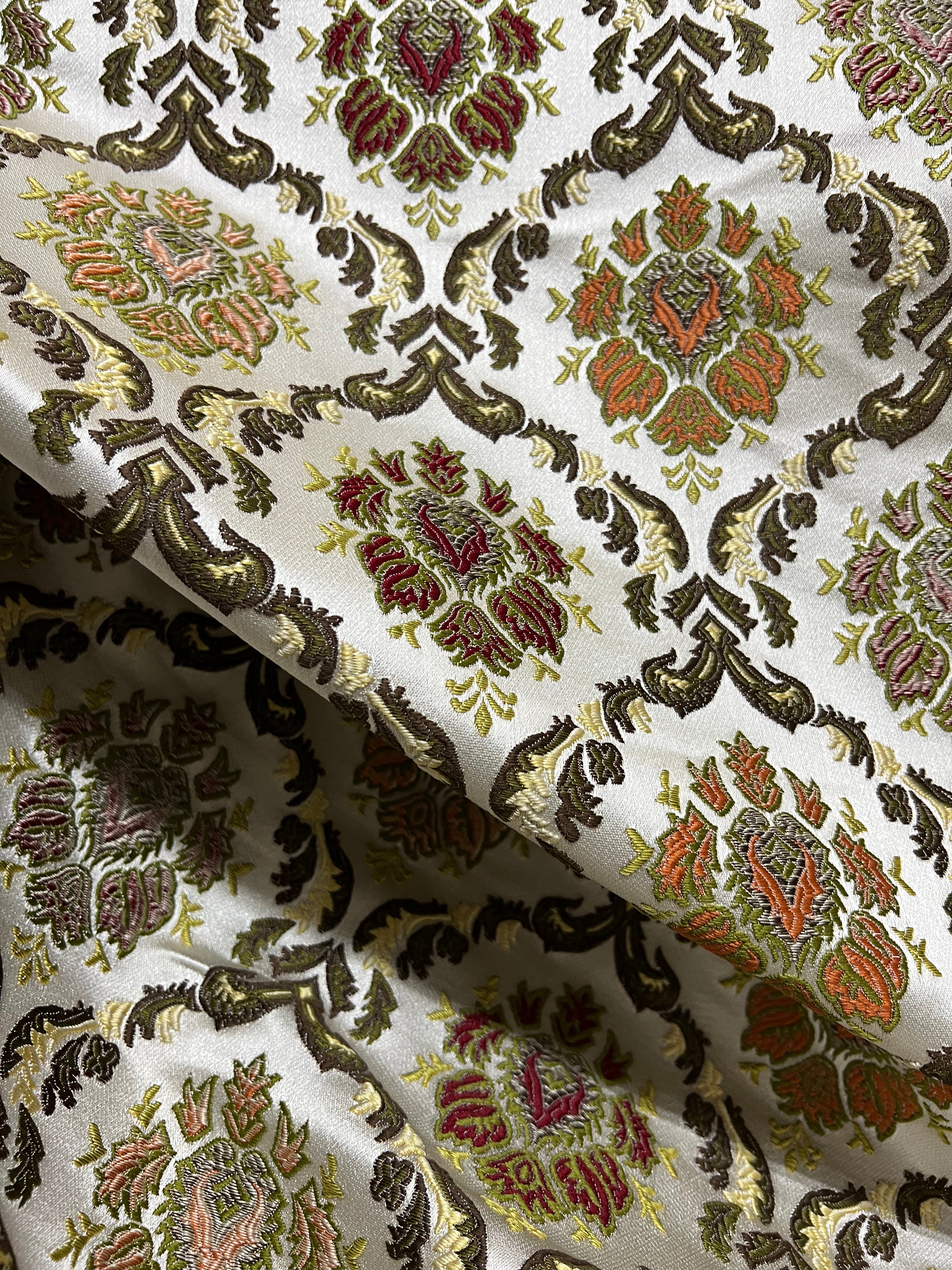 Decorative fabric with intricate Green floral pattern on a beige background