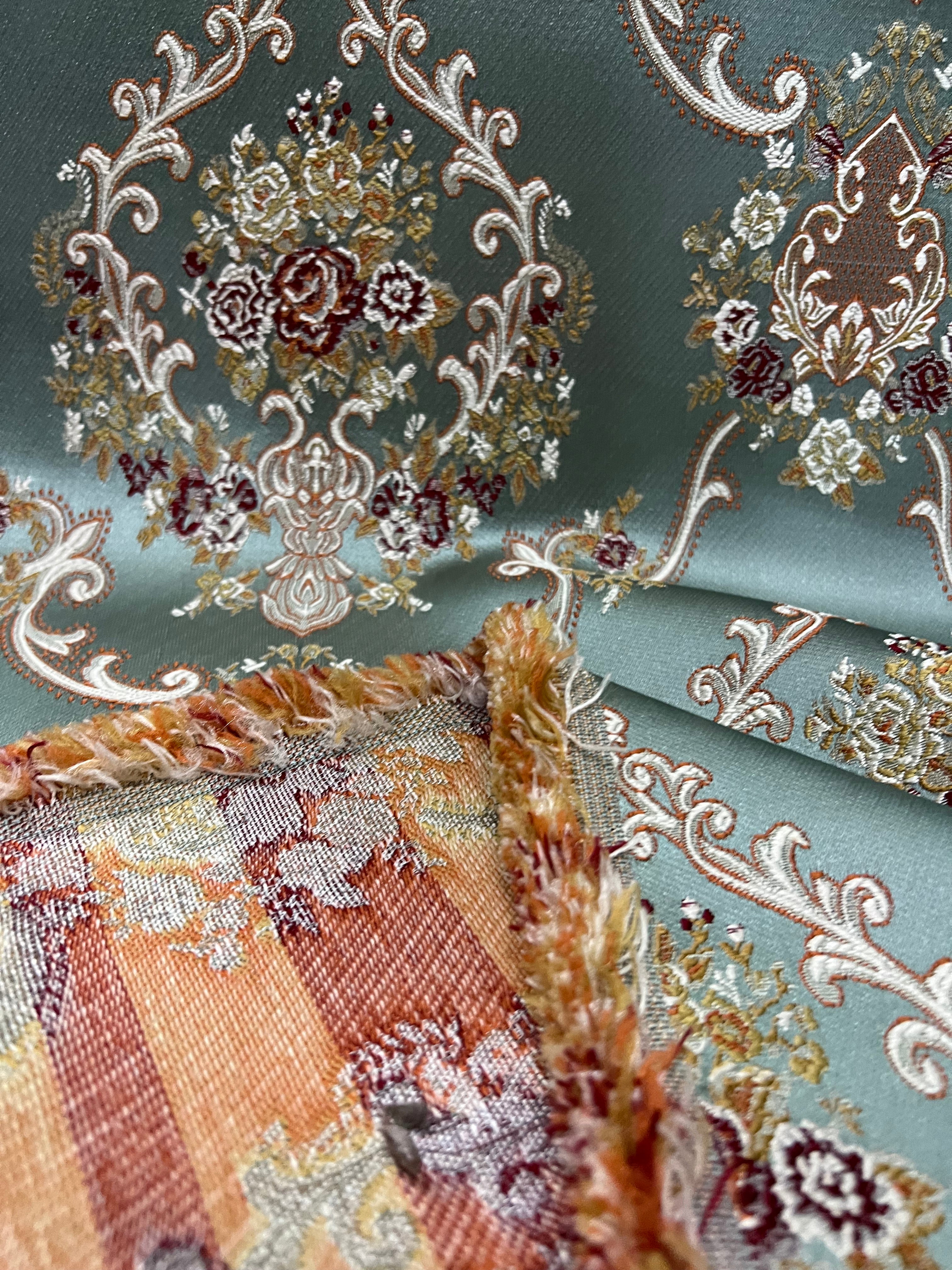 Decorative fabric with intricate floral damask on Teal Blue background