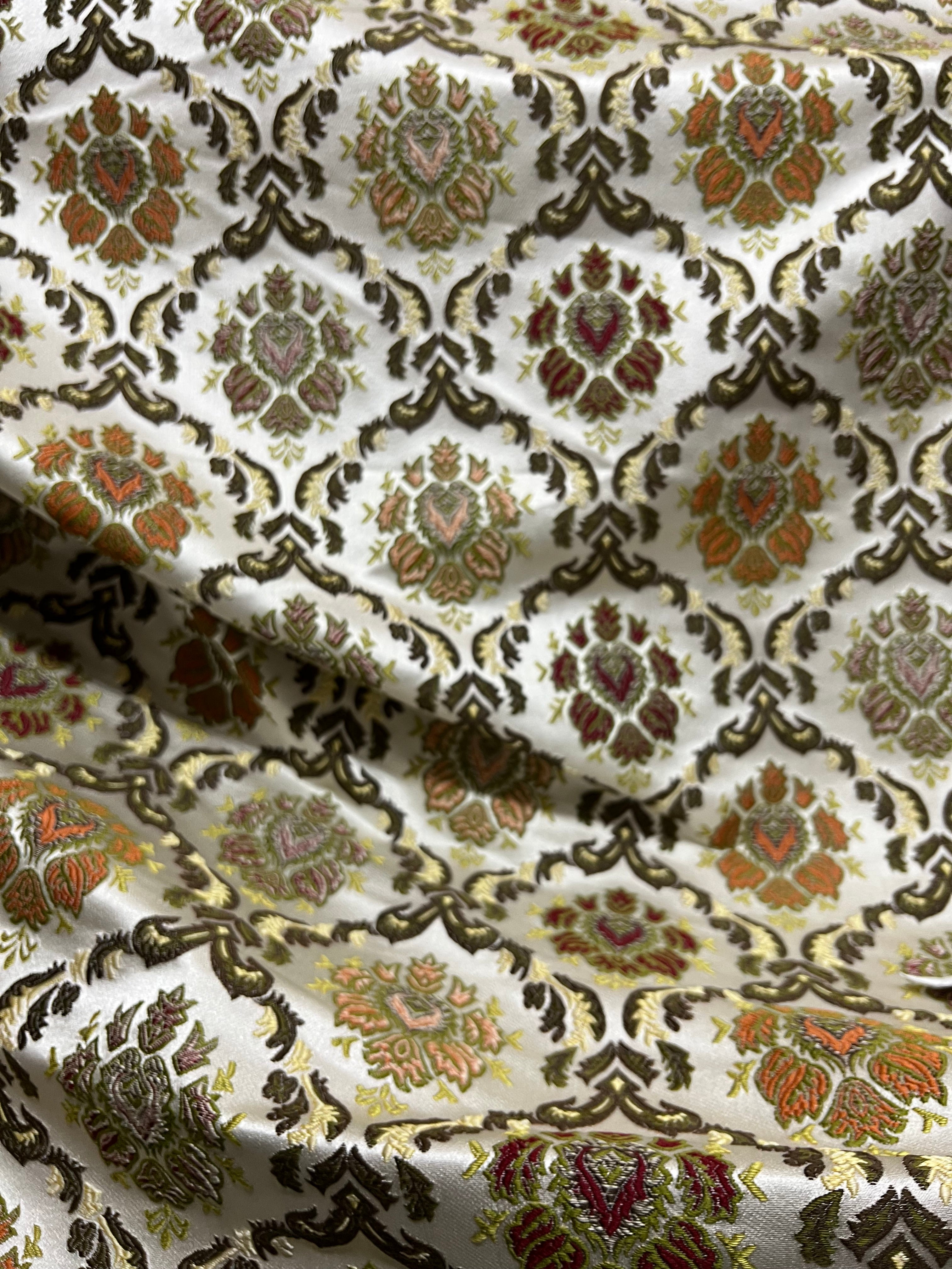 Decorative fabric with intricate Green floral pattern on a beige background