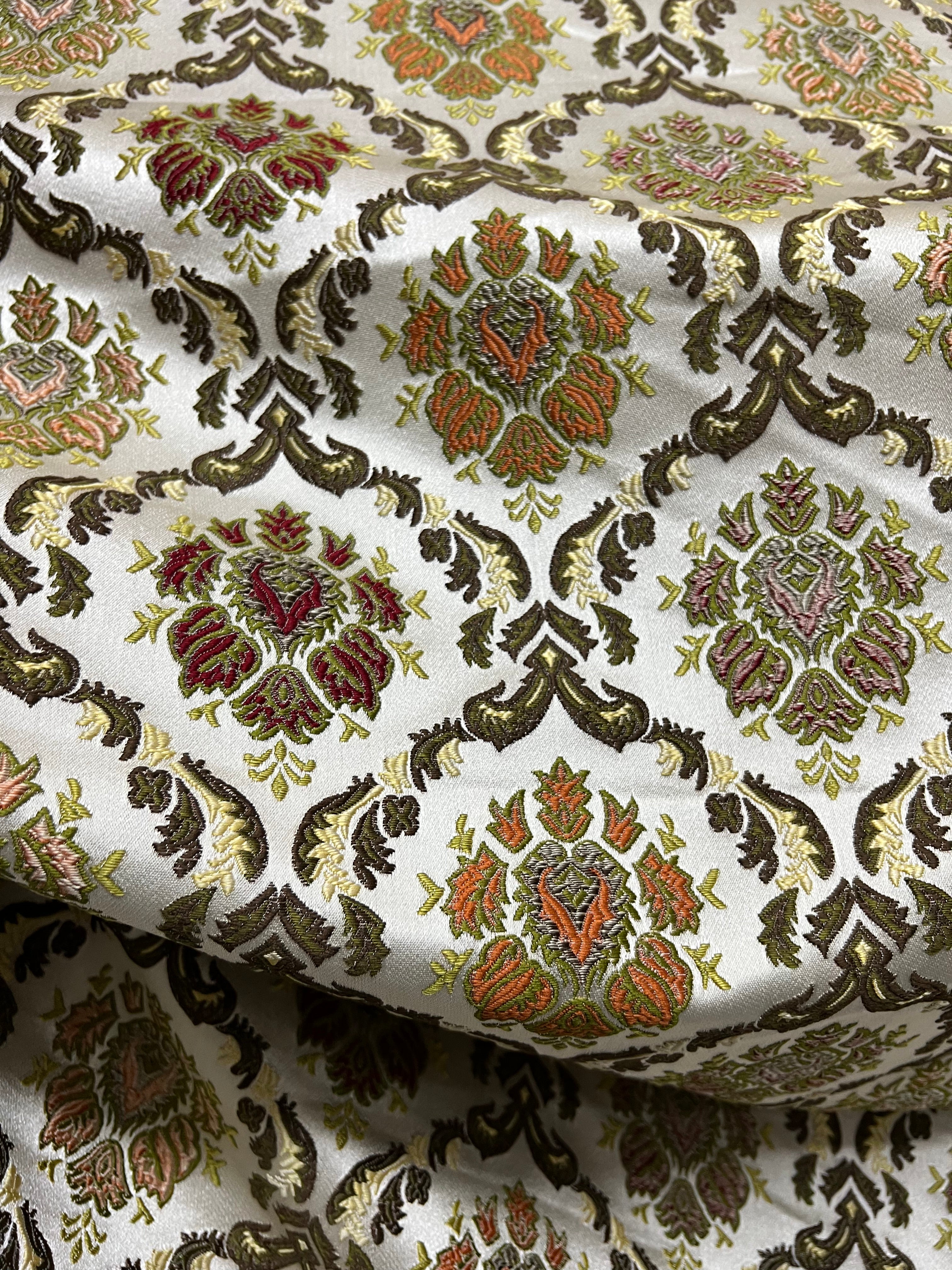 Decorative fabric with intricate Green floral pattern on a beige background