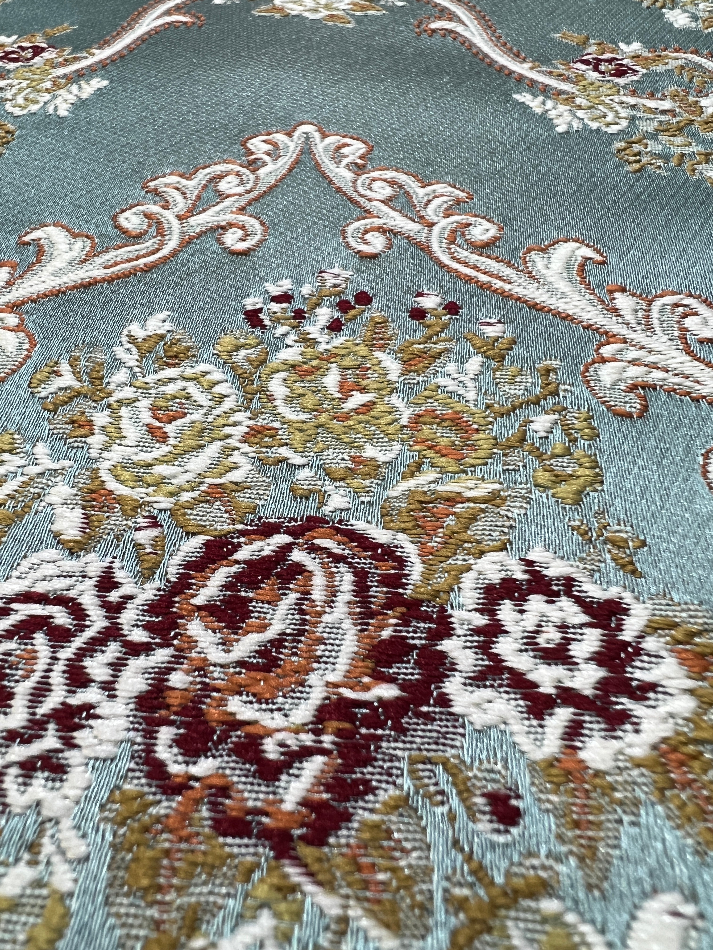 Decorative fabric with intricate floral damask on Teal Blue background