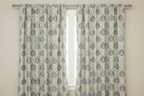 Decorative fabric with intricate Blue floral pattern on a beige background in curtain panel